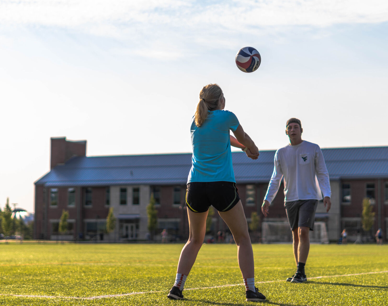 Two friends play volleyball